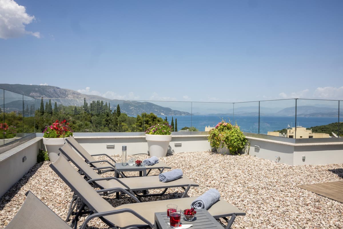 Terrace at Five Stars Villa, Kommeno, Corfu — outdoor dining with sea views over the Ionian